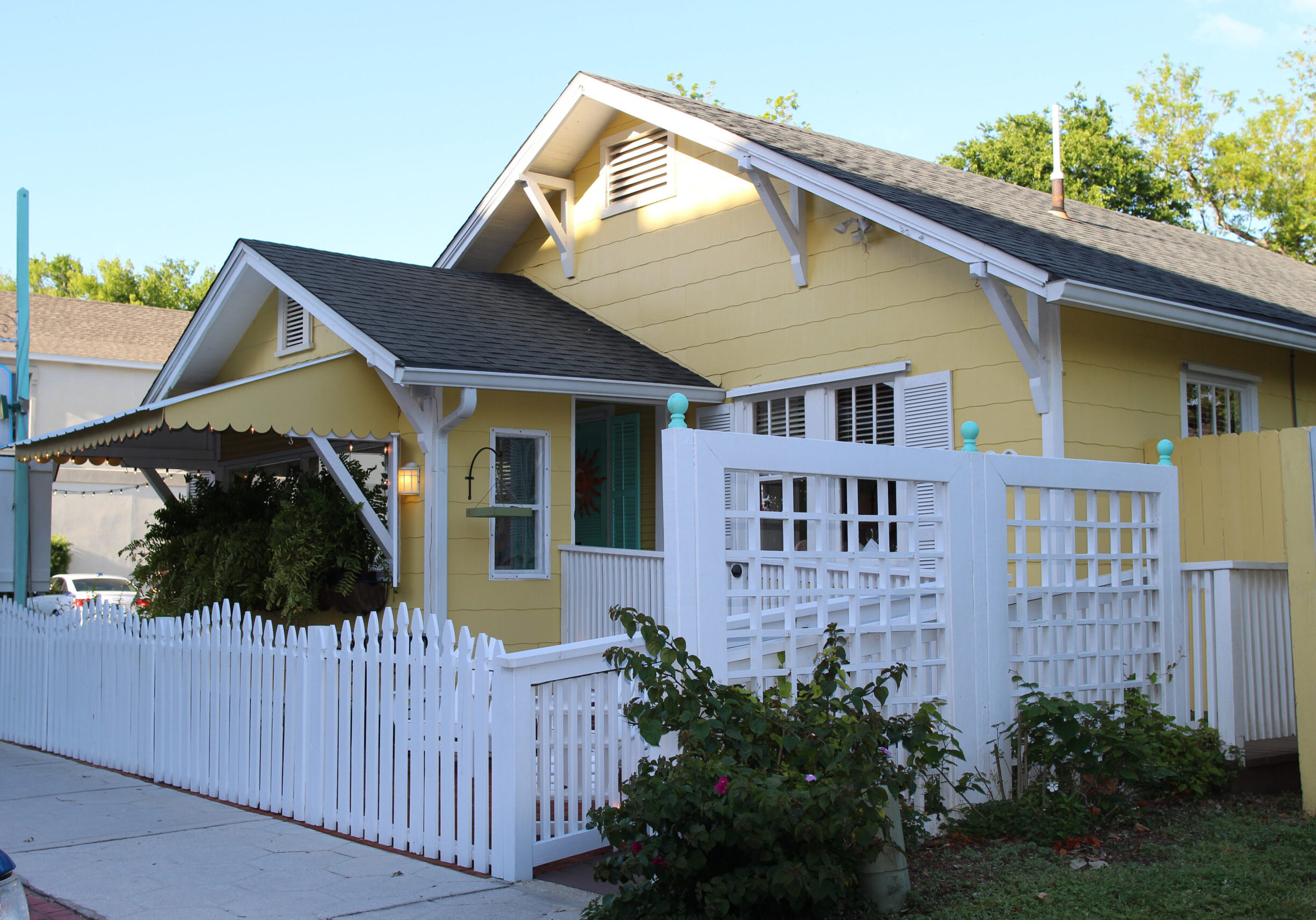 A small cozy house with a white fence and green bushes in the summer, Amelia island, Florida, USA
